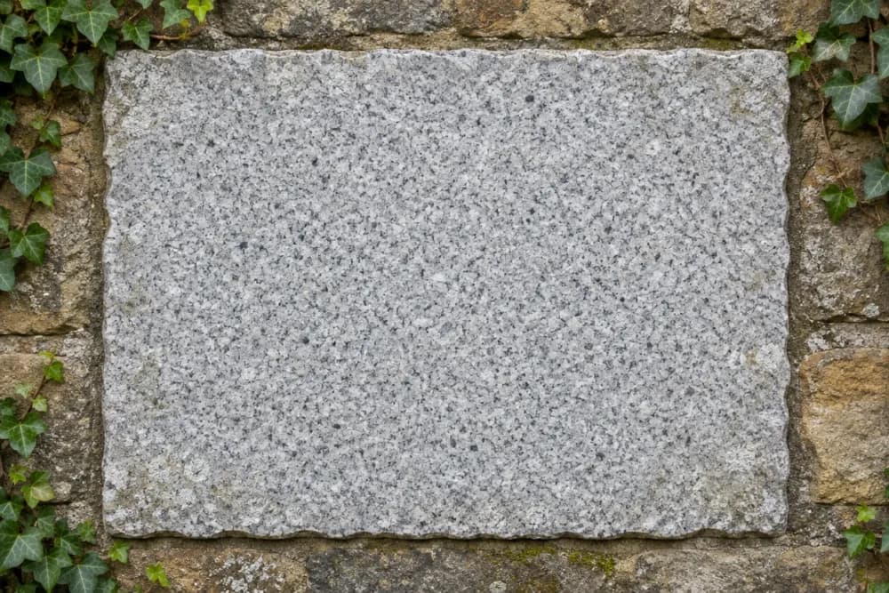 Granite plaque set into a garden wall